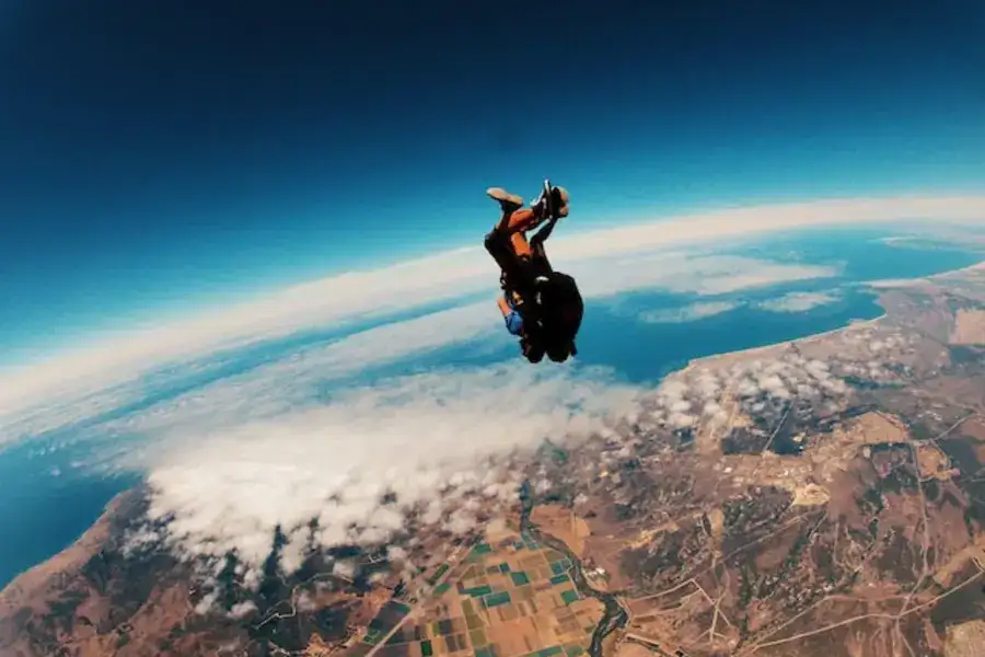 person skydiving on air during daytime